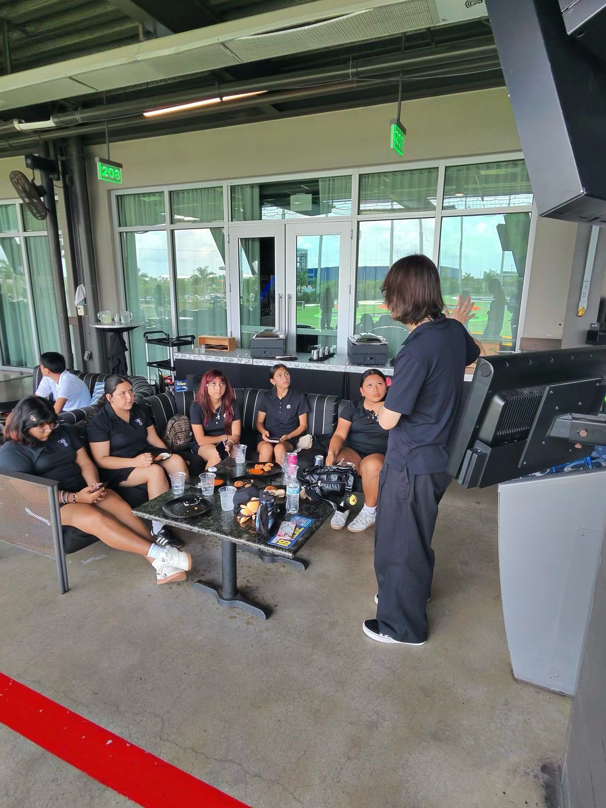 FFGF after-school program participants in team polos during a mentorship discussion
