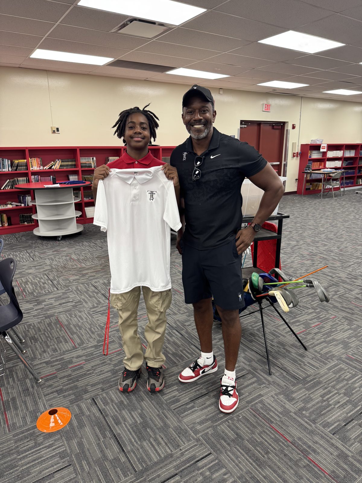 FFGF coach mentoring a youth participant one-on-one in a school library setting